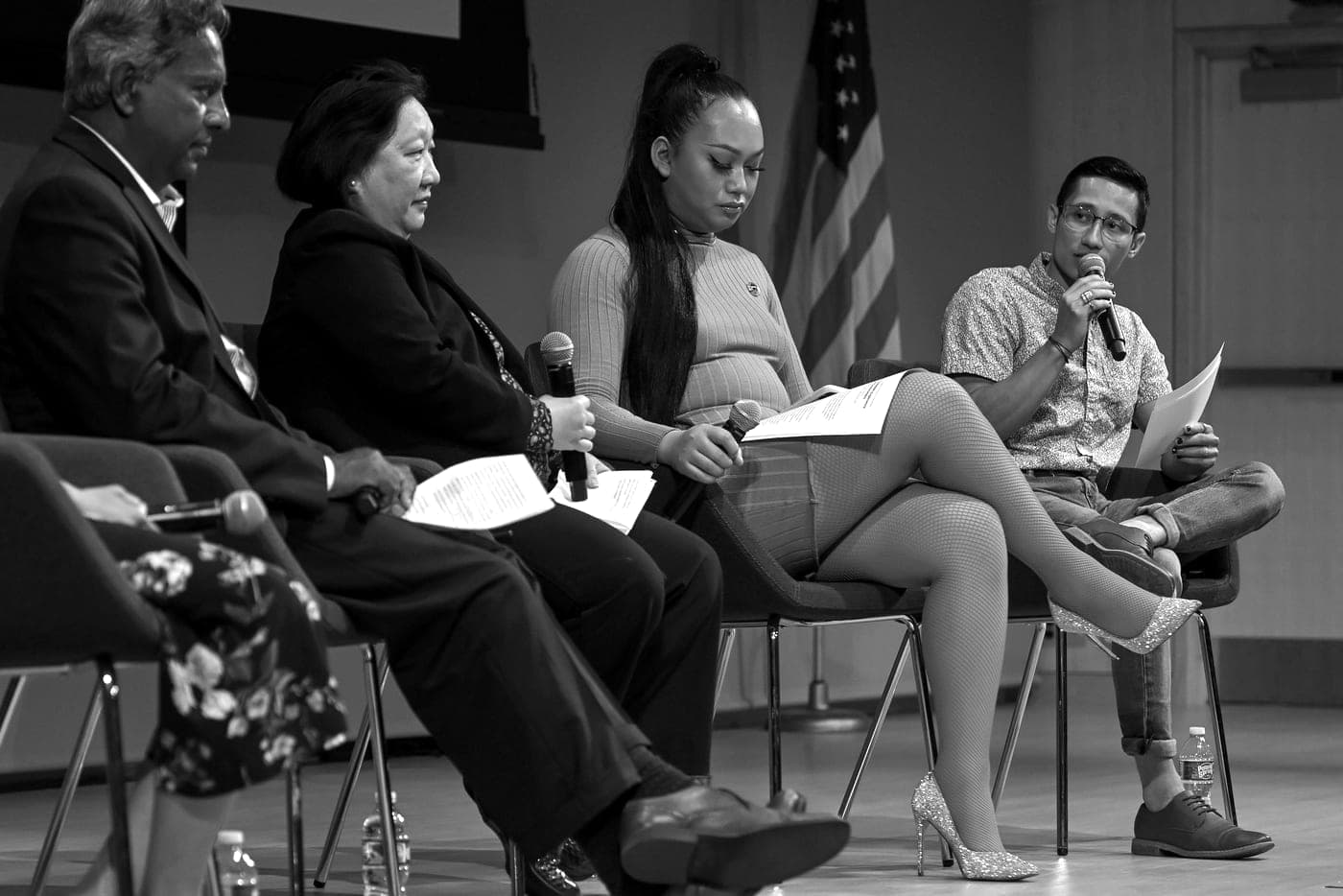 Ezra Zwaeli speaking on a panel, holding a microphone